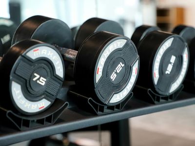Row of heavy dumbbells on a metallic rack